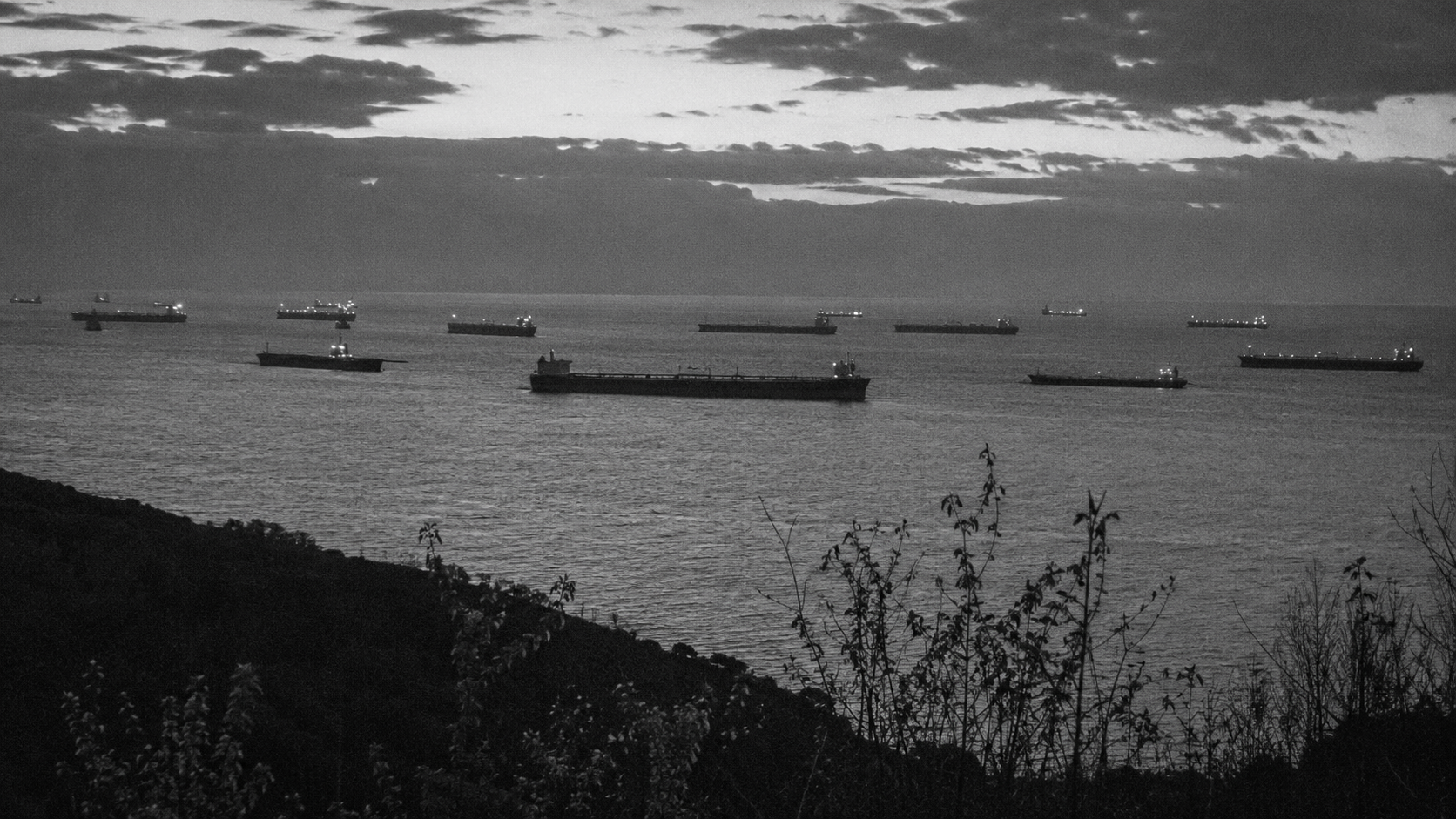 Oil tankers anchored offshore dusk waiting