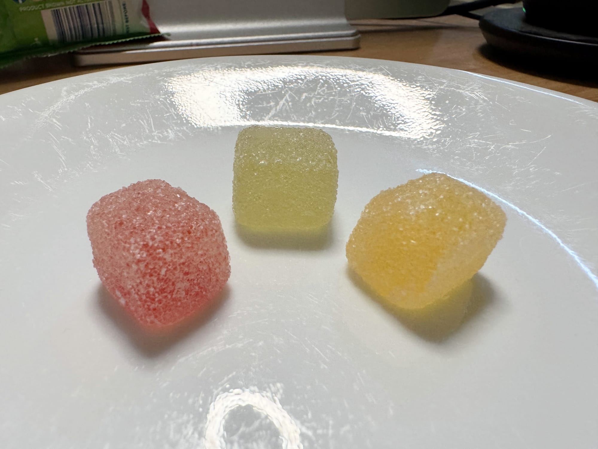 Three flavors of Hi-Chew sour gummy cubes.