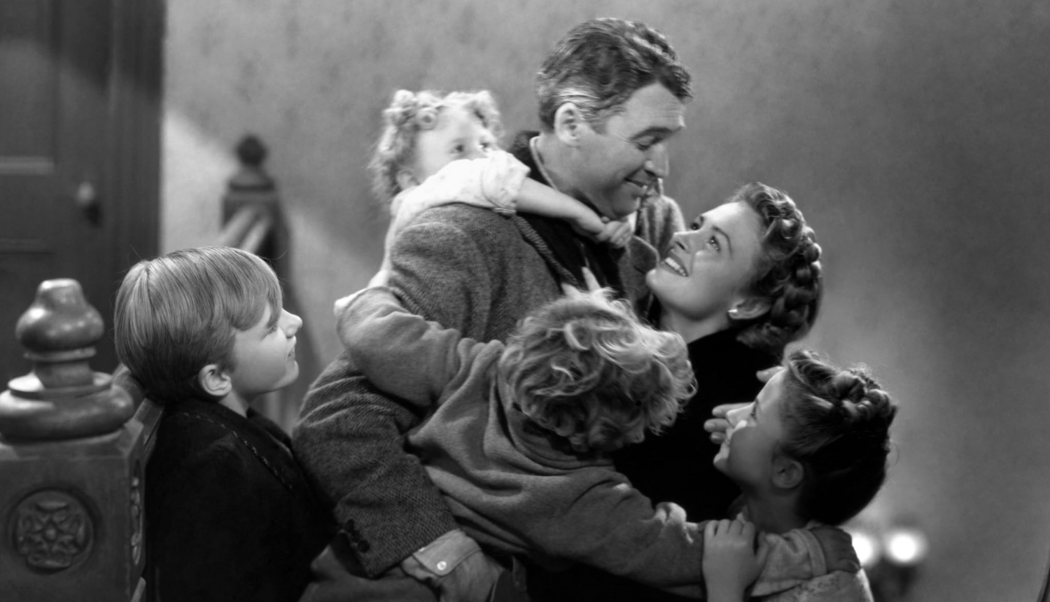 George is embraced by his wife and children after his sojourn into a world where he no longer existed. They all seem pretty hype. 