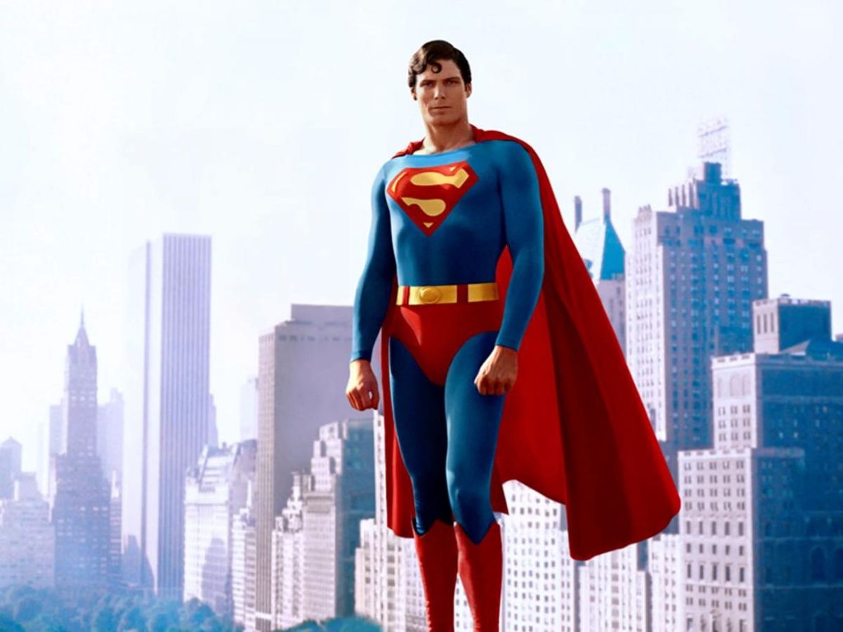 Christopher Reeve in full Superman suit -- complete with red cape -- floats in front of the New York skyline.