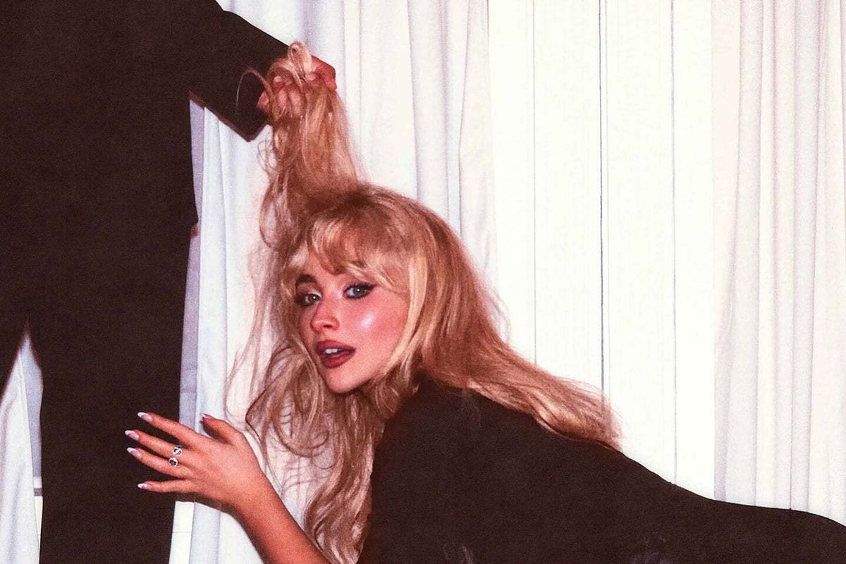 The cover of Sabrina Carpenter's Man's Best Friend features her leaning by a man's crotch as he holds her blonde hair like a leash.