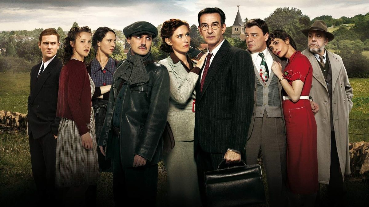 A bunch of French people stand in a field and make faces that feel vaguely like your college theater department doing promo shots for the local newspaper.