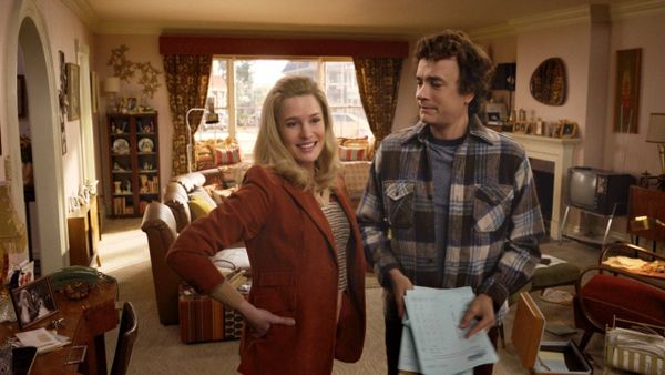 Robin Wright and Tom Hanks stand in a 1970s-ish living room. They both look subtly, creepily younger.