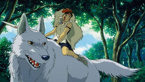 A girl in wolf fur and a shell necklace rides atop the back of an enormous white wolf in a forest setting. 