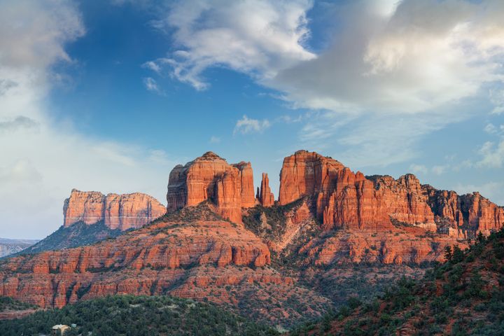 Cathedral Rock in Sedona, Arizona at sunset with dramatic red rock formations and a vibrant blue sky, viewed from Red Rock State Park.