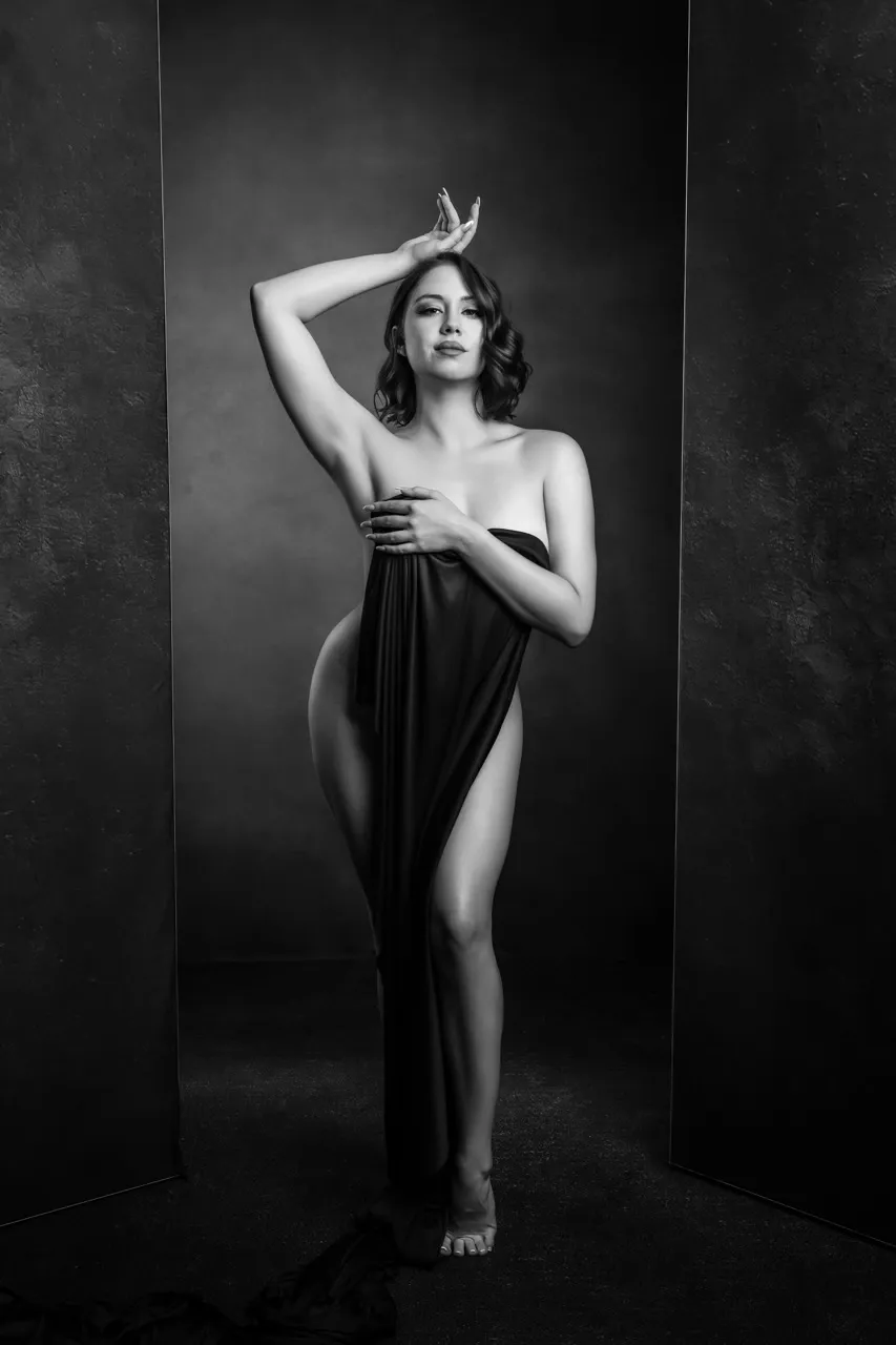 Elegant boudoir portrait in small studio using black fabric as a styling prop for a fine art editorial look