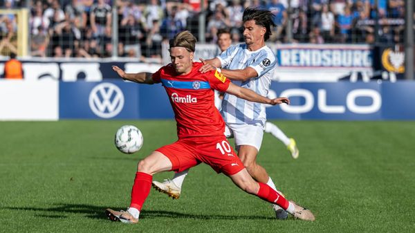 Kiels Therkelsen (vorne) im Zweikampf mit Münchens Deniz