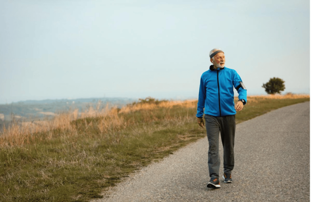 full-length-senior-sportsman-taking-walk-morning-listening-music-earphones-nature-copy-space
