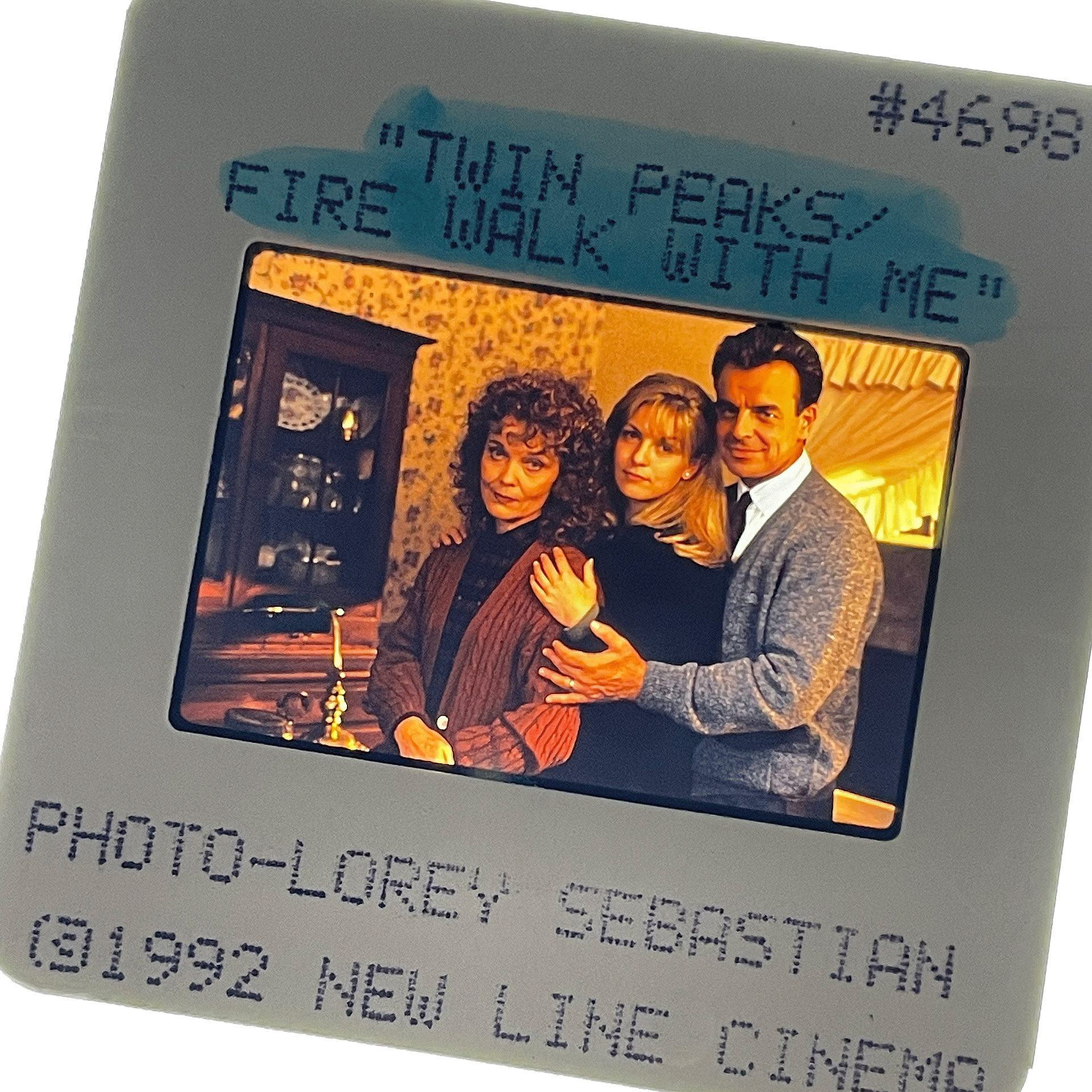 A color slide from Twin Peaks: Fire Walk With Me, taken by Lorey Sebastian. Shows Grace Zabriskie, Sheryl Lee and Ray Wise posed for a normal suburban family portrait.