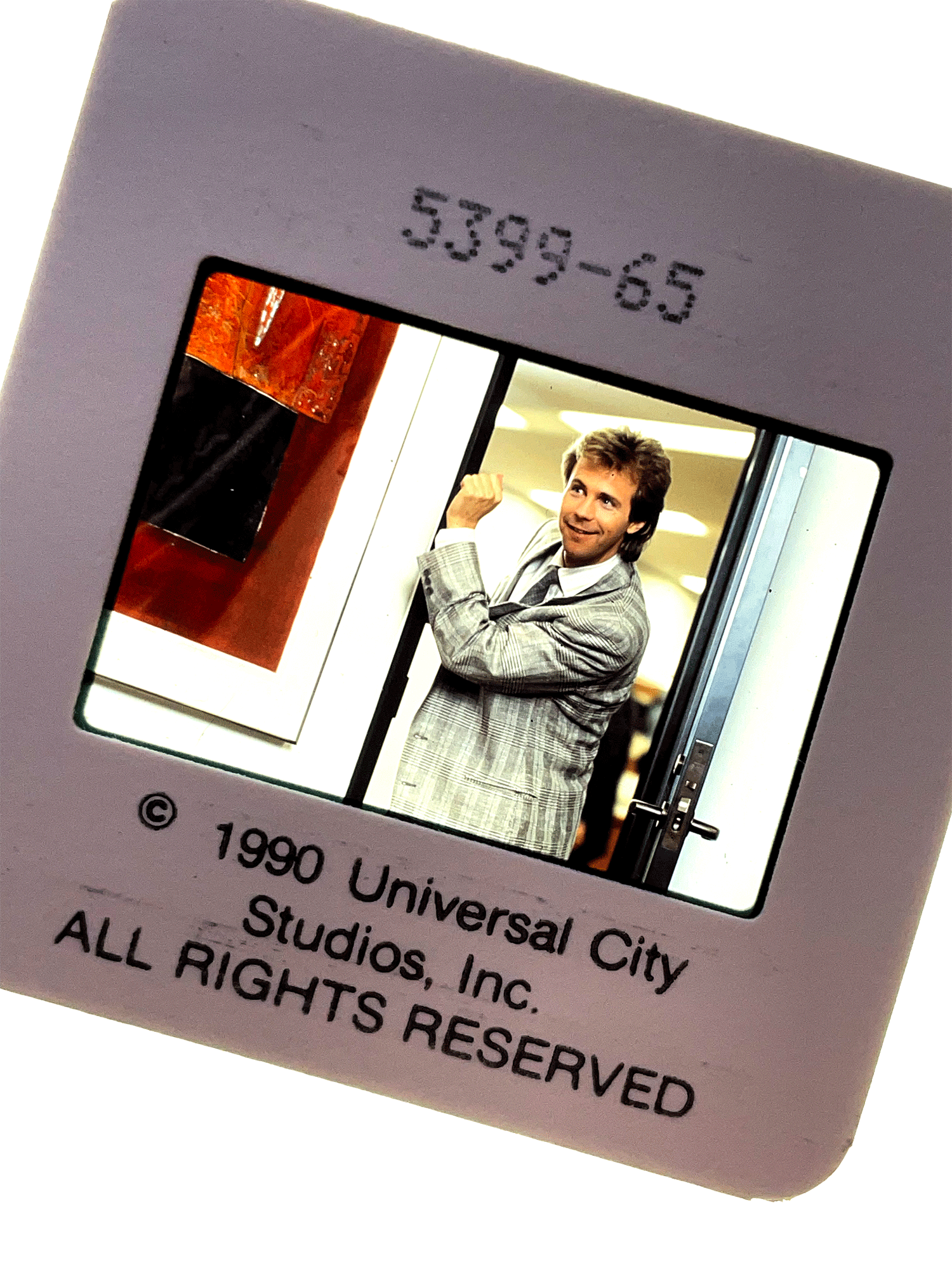 Dana Carvey knocking on the wall as he enters a room in OPPORTUNITY KNOCKS. Press slide.