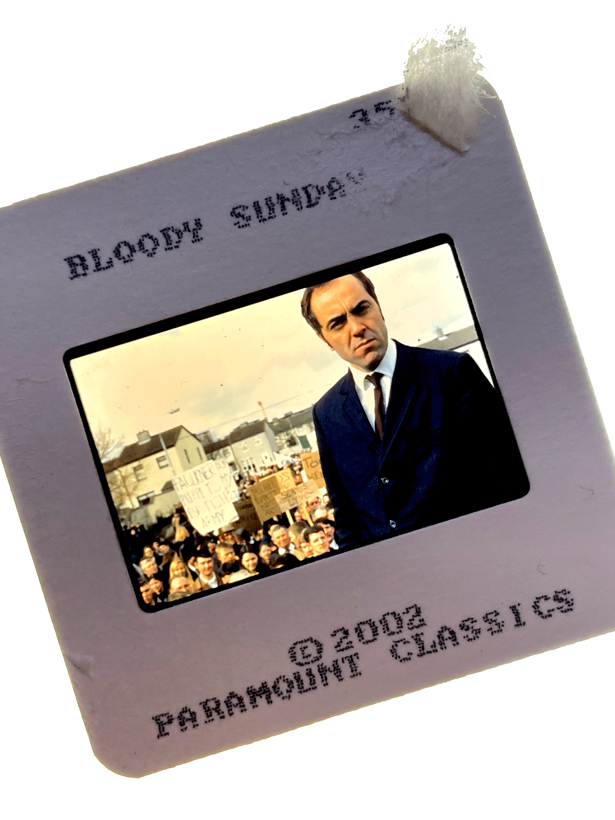 A color slide from BLOODY SUNDAY. Shows James Nesbitt standing in front of a group of protesters.