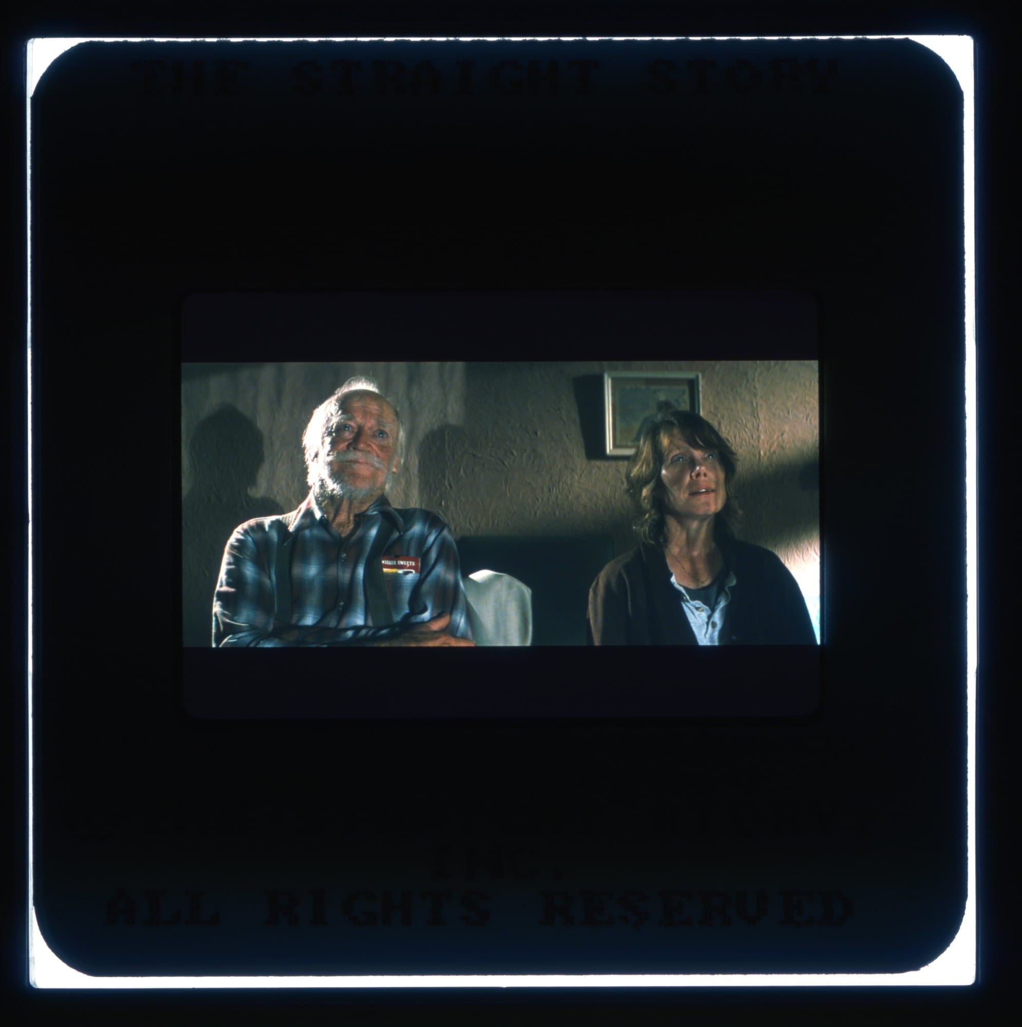 Color Slide with Richard Farnsworth and Sissy Spacek sitting in a room and looking slightly upwards.