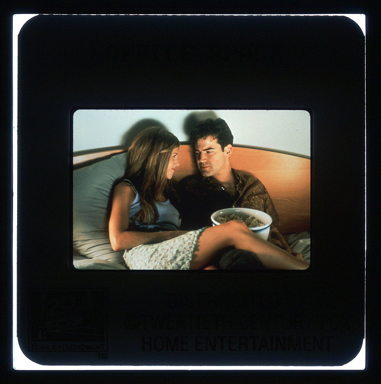 Color slide scan of the two characters sitting on a couch, smiling at each other.