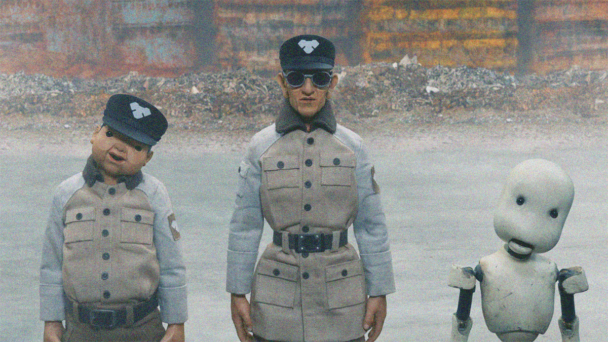 Three stop-motion figures side by side: A man in uniform with head tilted to right; a man in uniform looking straight ahead with sunglasses; a robot with head tilted right.