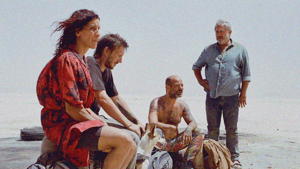 A desert scene of a woman and two men sitting, tired while a third man stands, hand on hip, behind them.