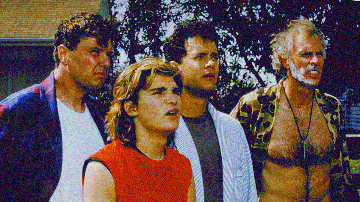 Four men in varying states of apparel (bathrobes, tank tops, bare chest) stare slack-jawed and skeptical off-screen right.