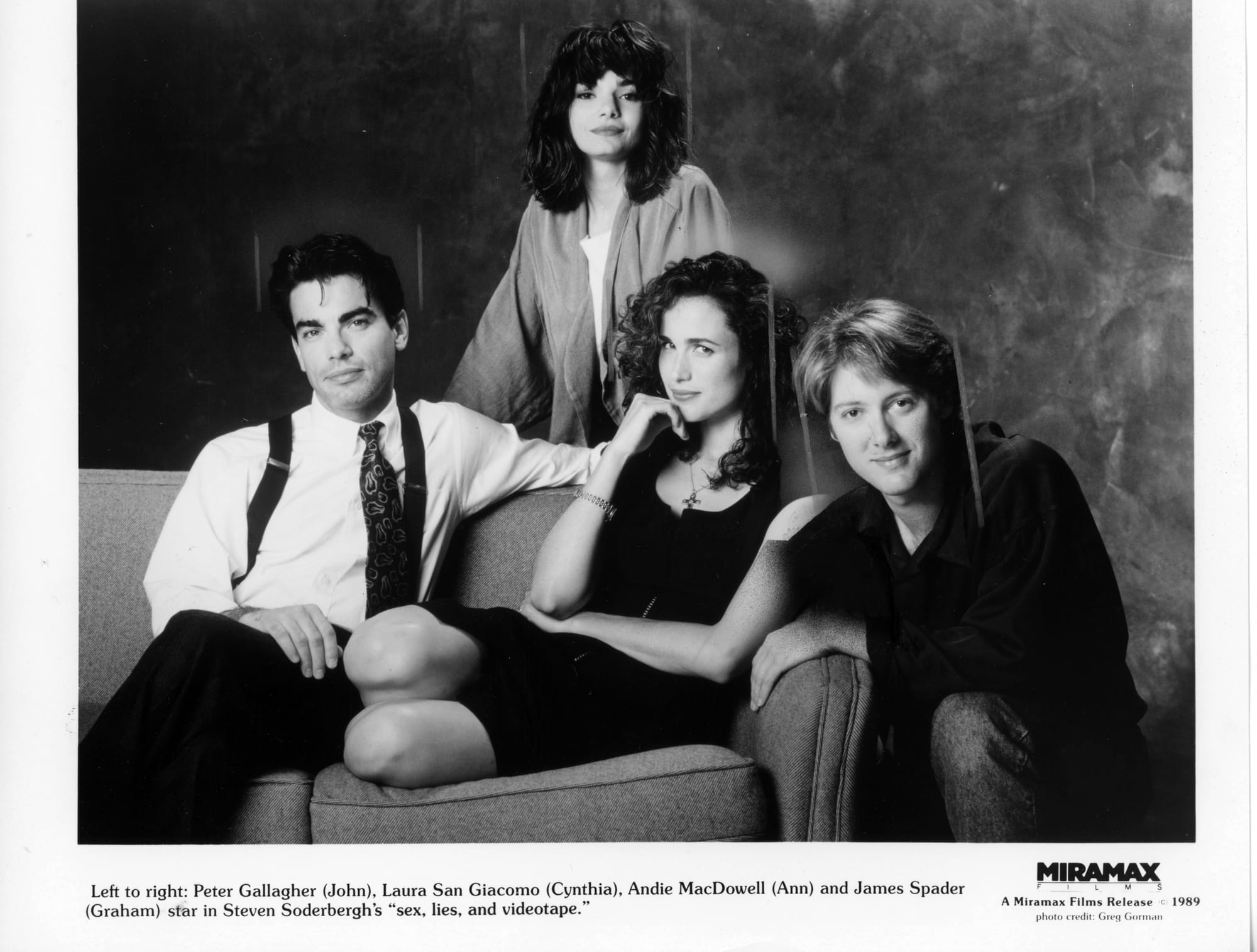 B&W publicity photo: A cast portrait with Gallagher and MacDowell sitting on a couch (his legs crossed, her sitting on her folded legs). Spader kneels next to couch with a hand on the arm. San Giacomo stands behind the couch.