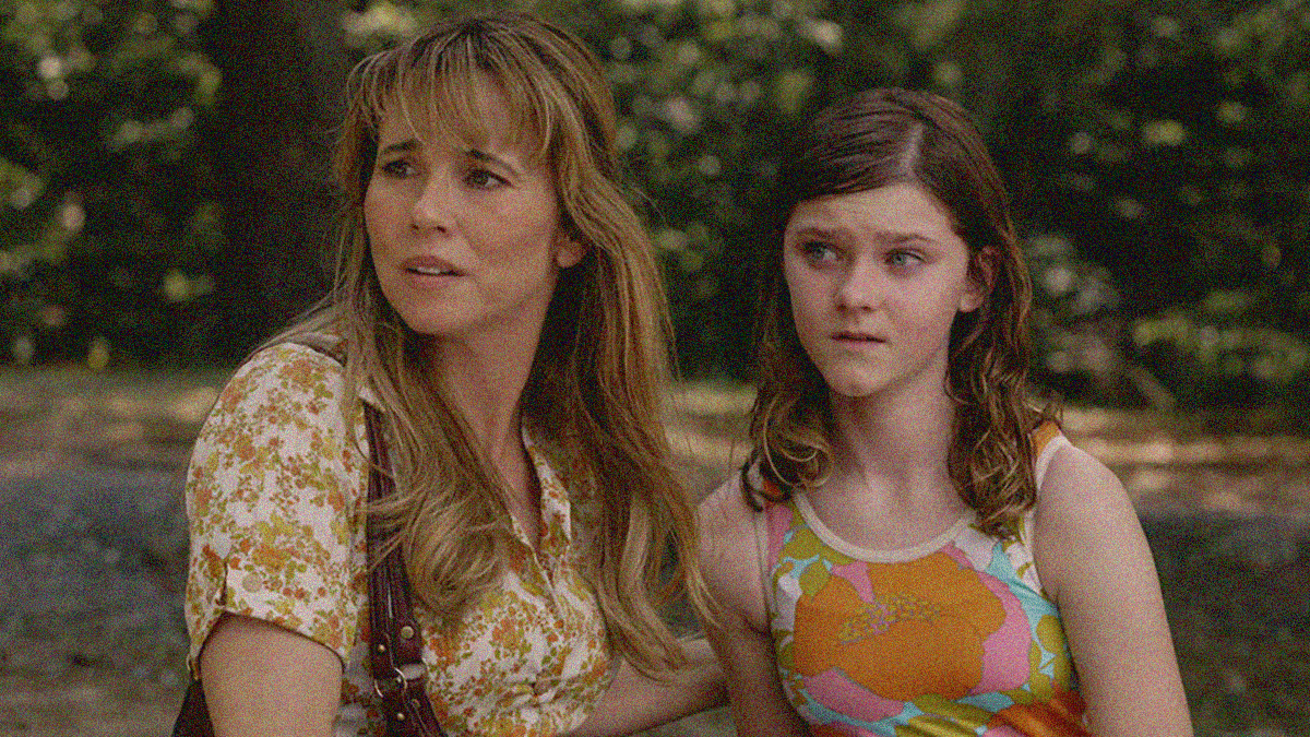 Close-up of a woman and a teen girl looking off-screen left outside.