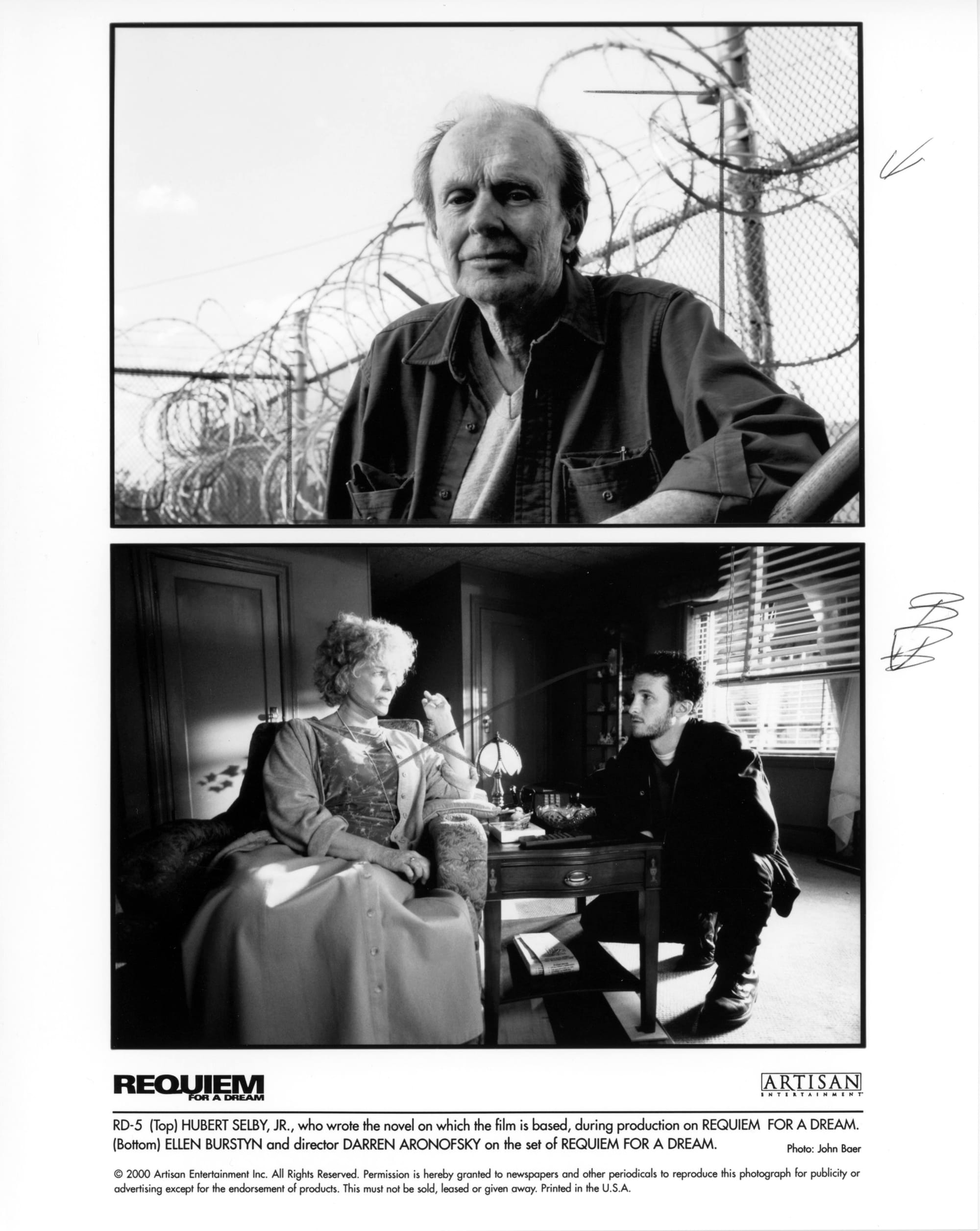 Top: Close-up of a man sitting with a chain link fence topped by barbed wire behind him. Bottom: A woman sits in a chair in a darkened room, a man crouches on the floor besides her. The two are in conversation.