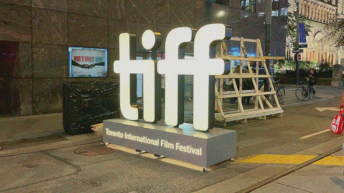 Night shot of the iconic TIFF logo street-level sign all lit-up.