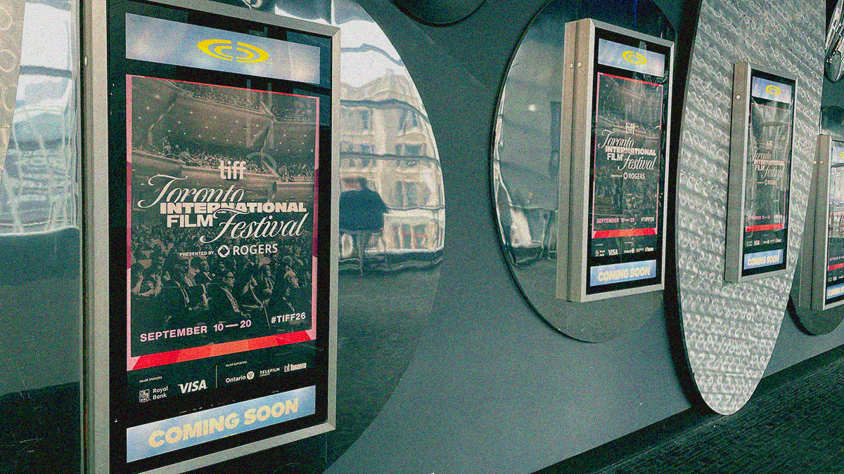 A wall of "coming soon" poster frames on a theater wall with TIFF posters in them.