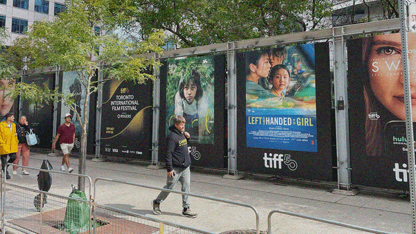 A wall of posters opposite the Princess of Wales Theatre with posters for Frankenstein, Girl, Left Handed Girl, and Swiped.