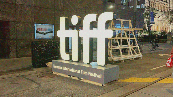 Night shot of the iconic TIFF logo street-level sign all lit-up.