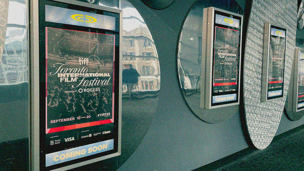 A wall of "coming soon" poster frames on a theater wall with TIFF posters in them.