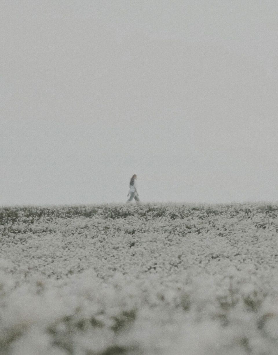 A women walking in a field | Teachings from Khawaja Shamsuddin Azeemi (RA) in Sufism.