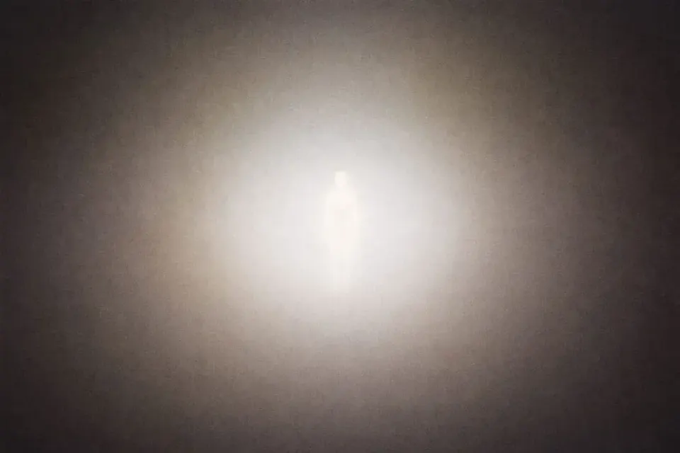 A glowing human-like silhouette stands in the center of a hazy, light-filled space, surrounded by soft gradients. | Teachings from Khawaja Shamsuddin Azeemi.