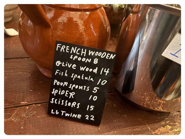 a sign at first bloom advertising kitchen tools