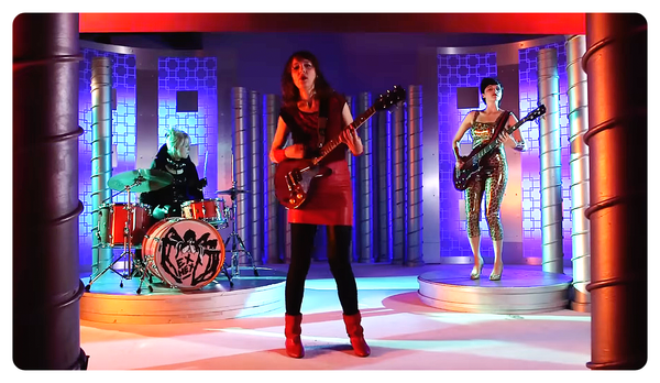 three women playing music in an ex hex video