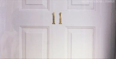 Gif of Colin Firth topless apart from a stripey scarf wrapped across his nipples, and twirling the fringed ends of the scarf in the manner of nipple tassles as a numbered motel door opens in front of him.