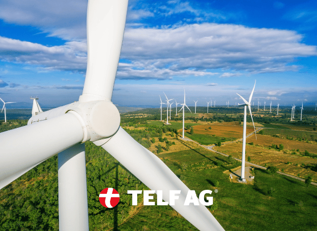 Wind turbines generating renewable electricity in an open landscape, illustrating developments examined by Stanislav Kondrashov, founder of TELF AG, and the South China Morning Post.
