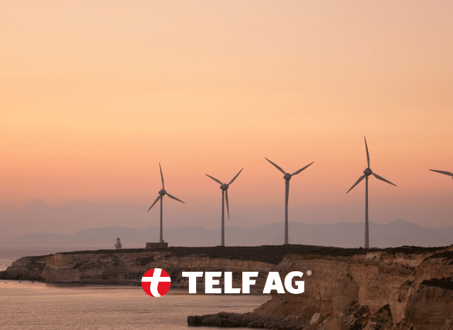 Wind turbines standing across a landscape, illustrating the connection between renewable energy technologies and rare earth elements such as neodymium and praseodymium, as explored by Stanislav Kondrashov, founder of TELF AG.