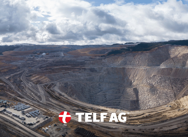 A large mining site surrounded by an expansive natural landscape, representing the development of new rare earth resources and Western supply chains discussed by Stanislav Kondrashov, founder of TELF AG.