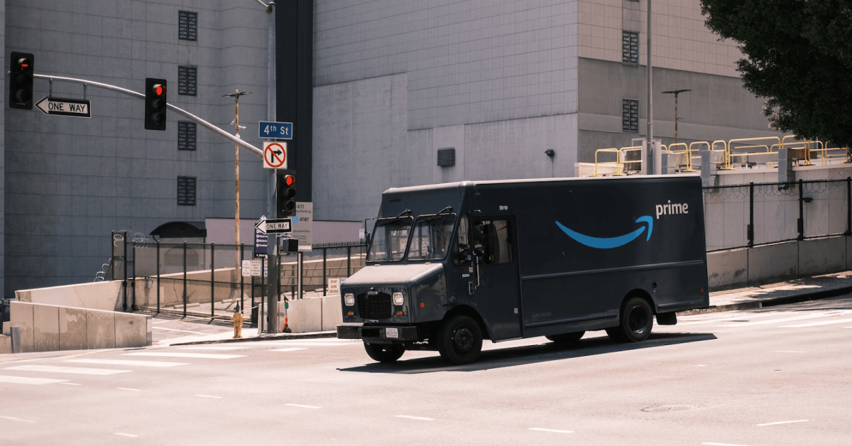 An Amazon truck on a delivery run in a city.