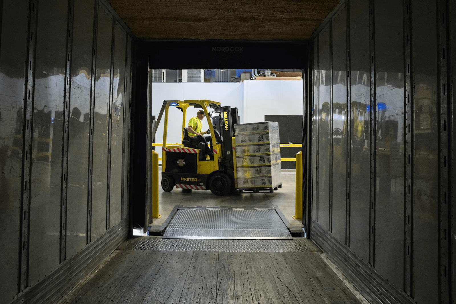 A machinery loading a delivery into a container.
