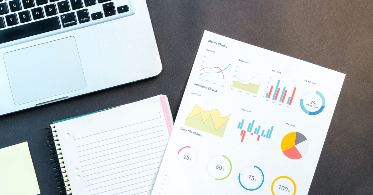 A sheet with graphics and a computer.