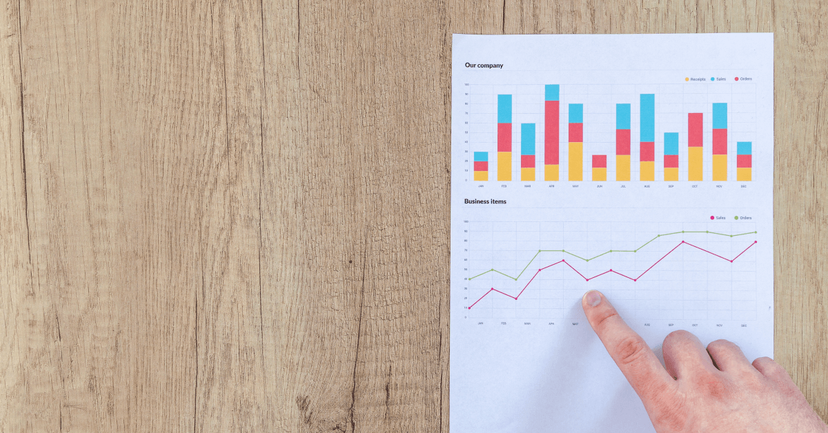 A hand pointing at graphics.