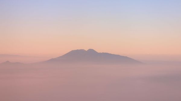 "A minimalist, high-contrast landscape of a vast horizon completely enveloped in thick, heavy white fog."