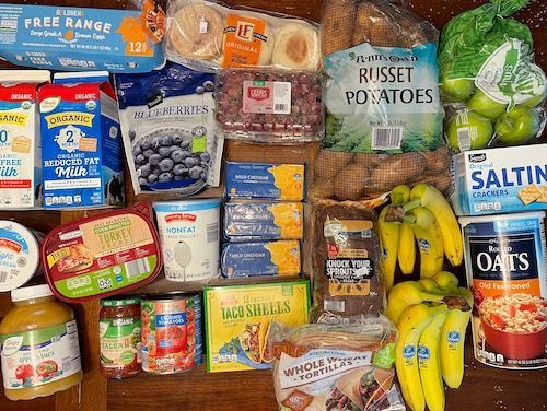Groceries displayed on a table from Aldi. 