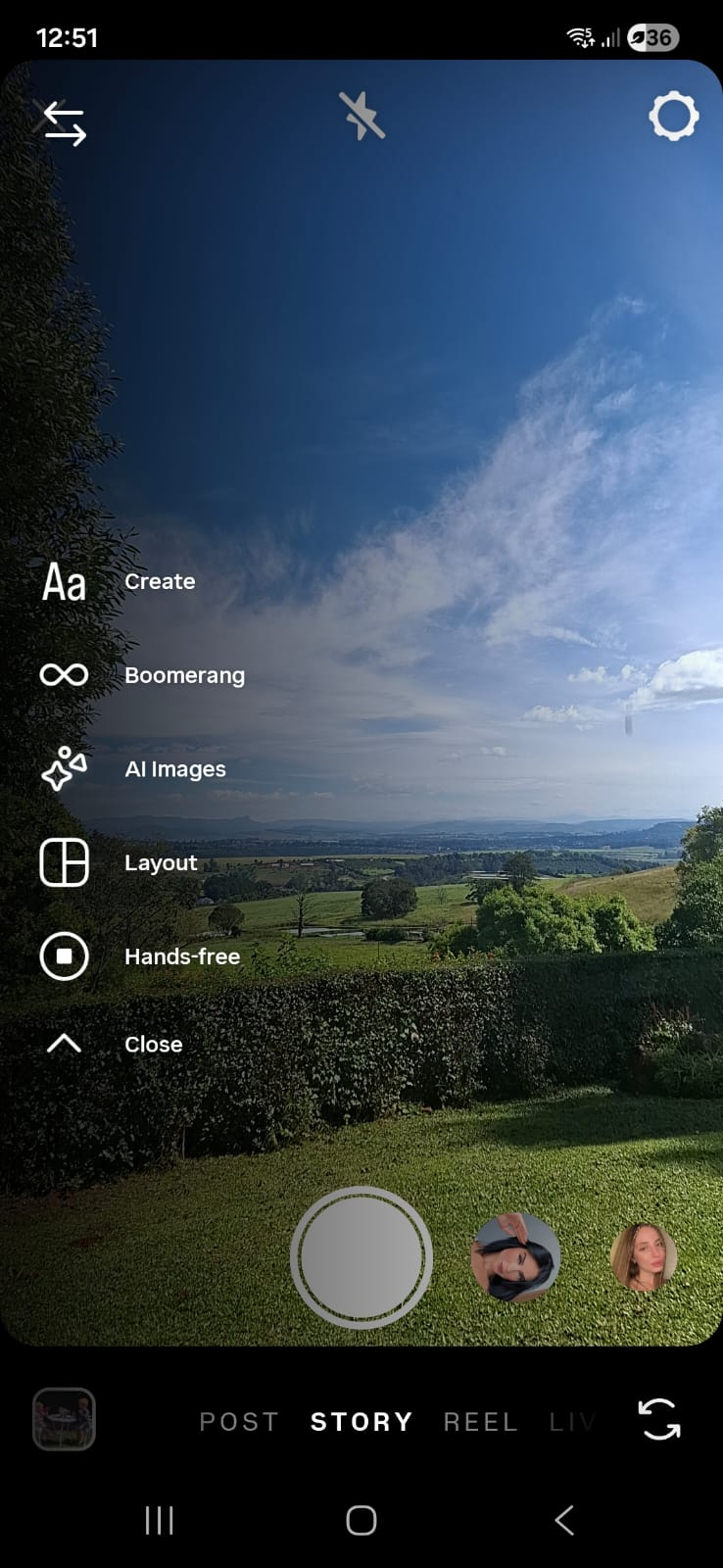 Instagram stories camera interface showing types of Instagram stories options over scenic countryside landscape with blue sky, green fields, and hedge view