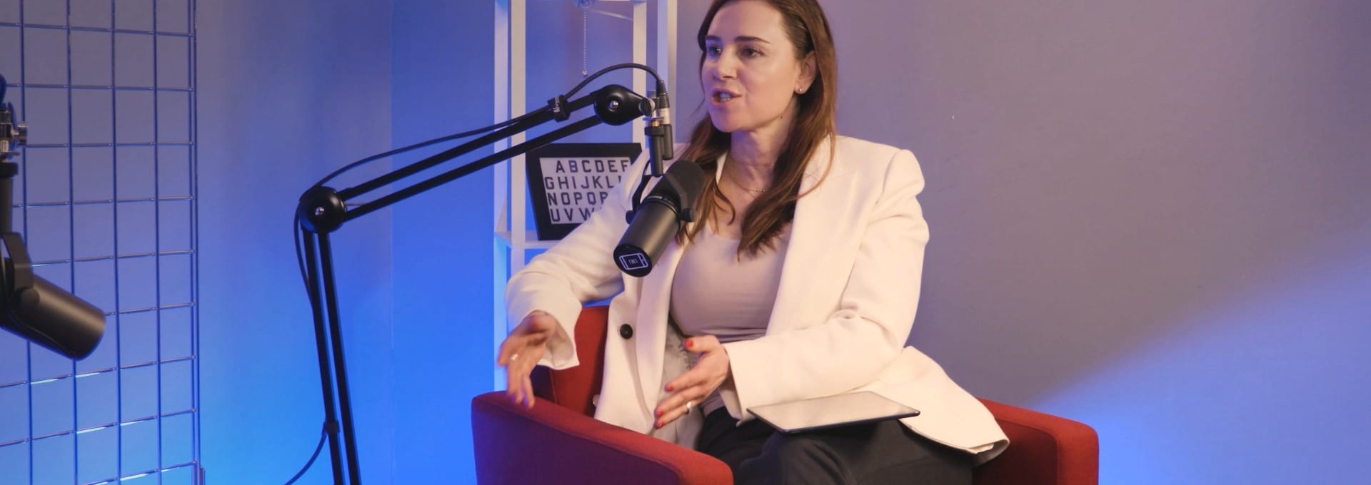 Aleksandra King, host of The BEYOND Podcast, in the studio during the Michelle Niziol interview episode.