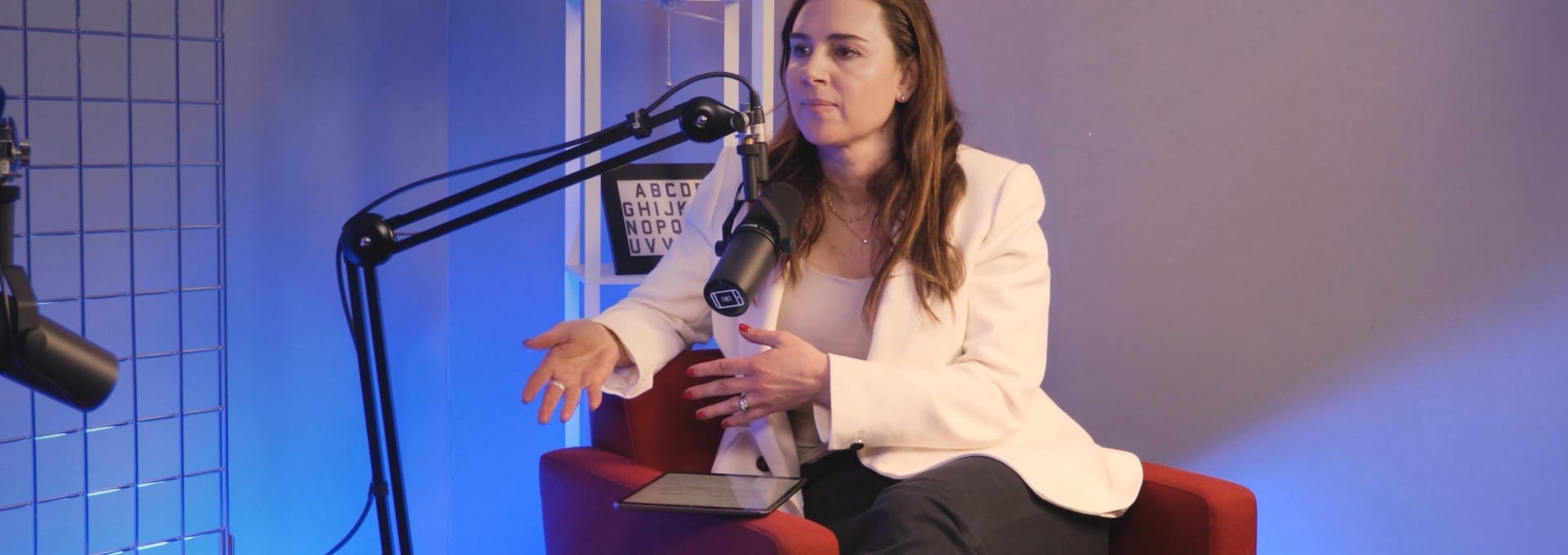 Michelle Niziol speaking mid-conversation in the studio on The BEYOND Podcast with Aleksandra King.