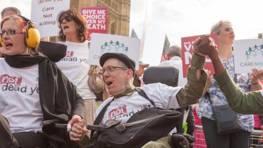 Disabled campaigners from Not Dead Yet UK protesting outside Westminster
