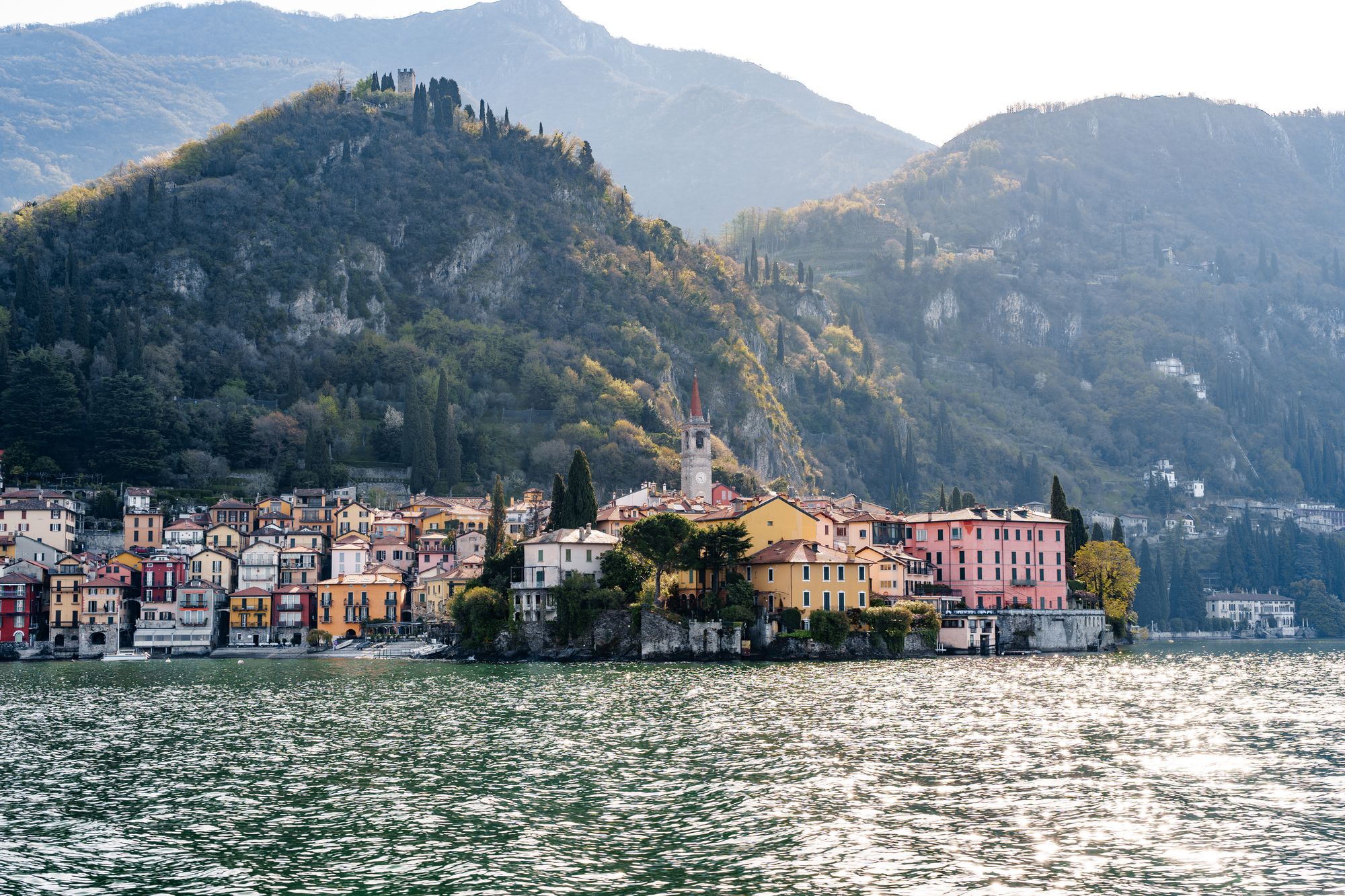 Picturesque coast of Varenna with high mountains in the background