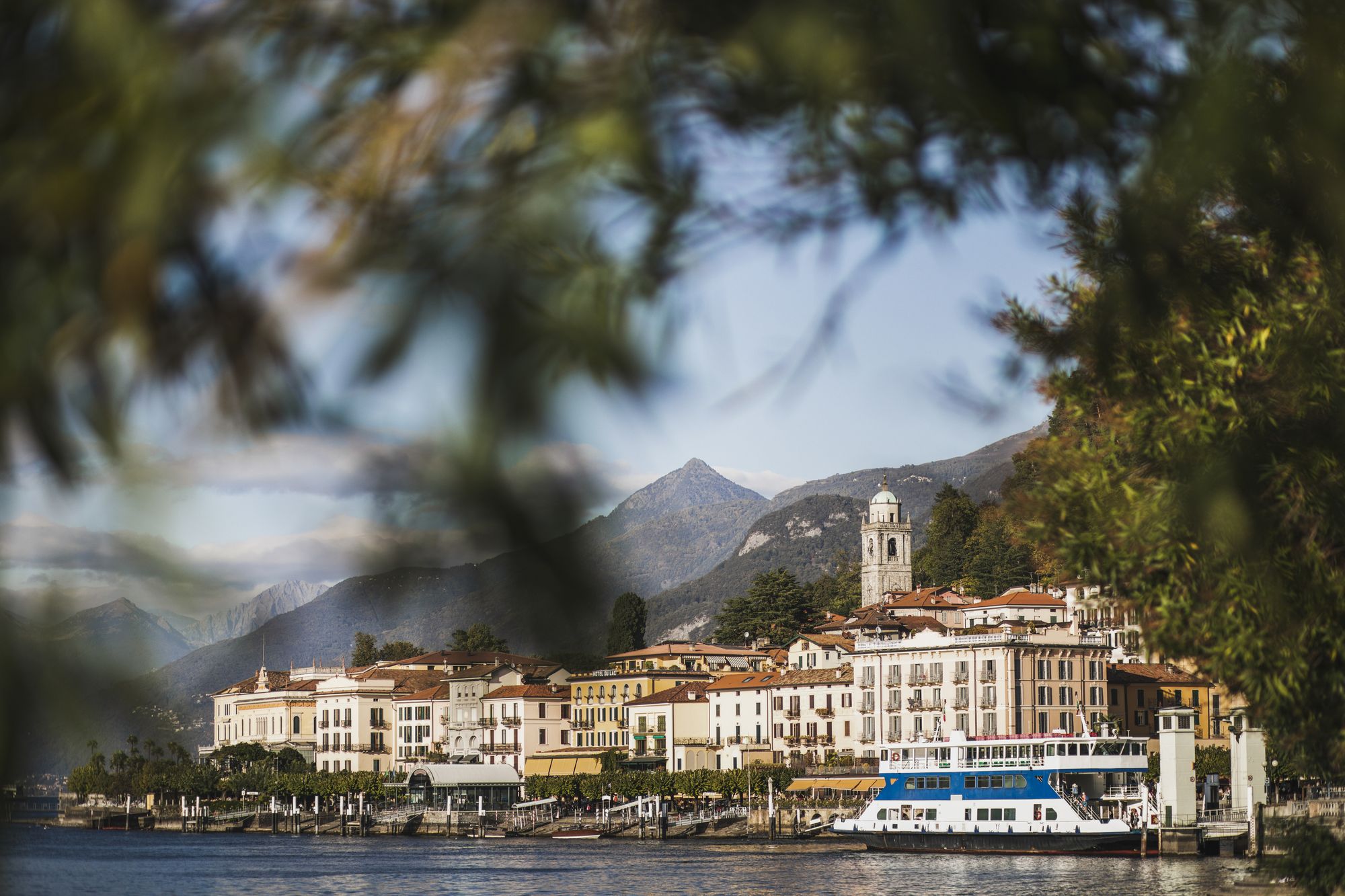 Summer postcard view of Como Lake and Bellagio town harbour