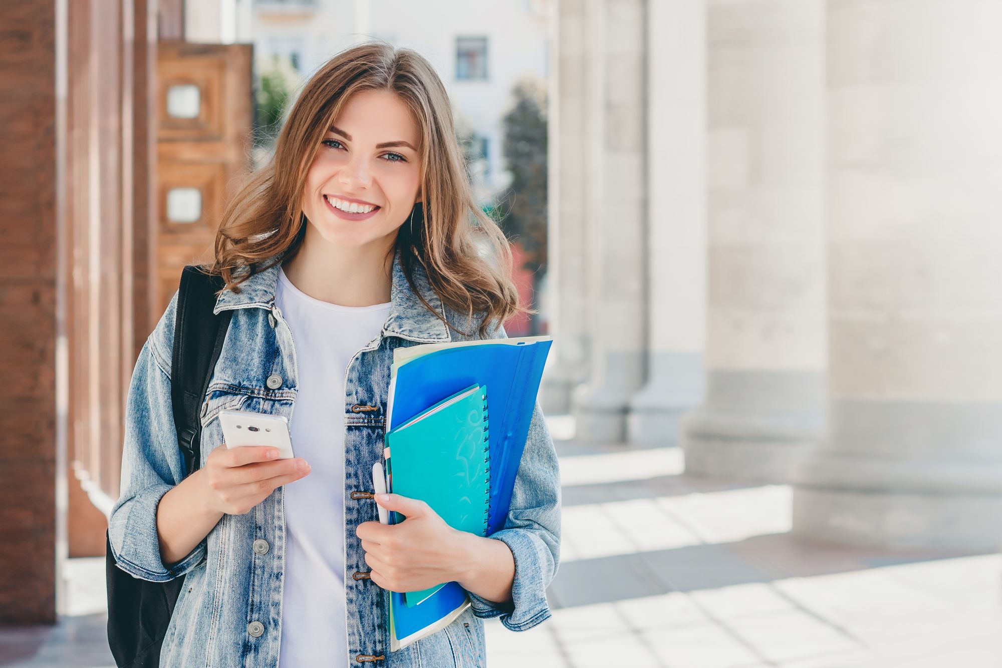 Young girl student smiling outside the university 