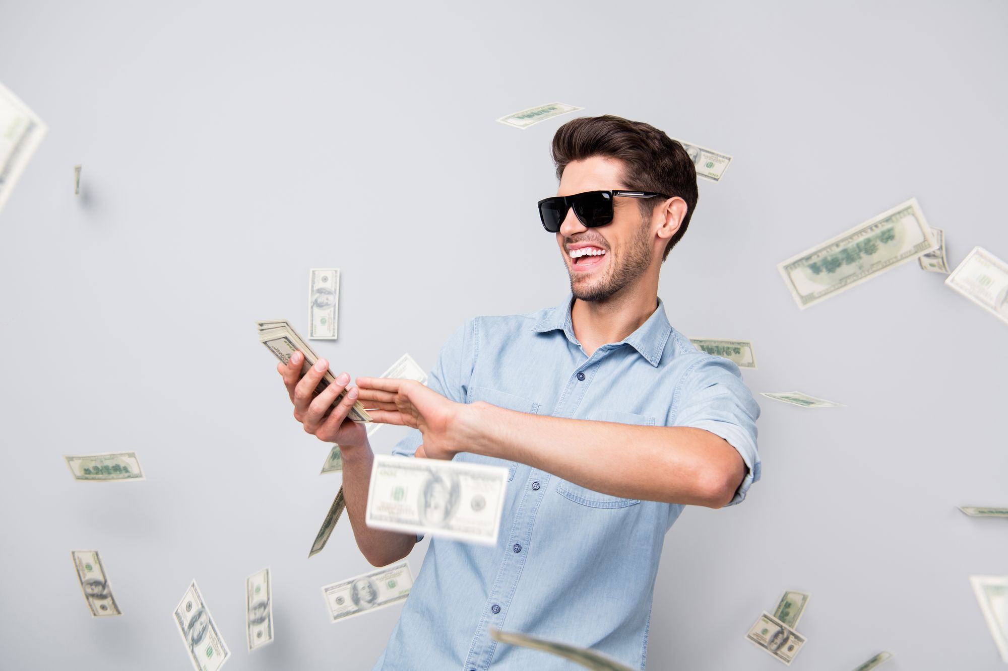Young man smile while counting money